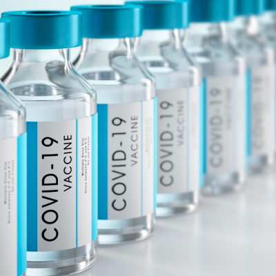 Row Covid-19 or Coronavirus vaccine flasks on white background