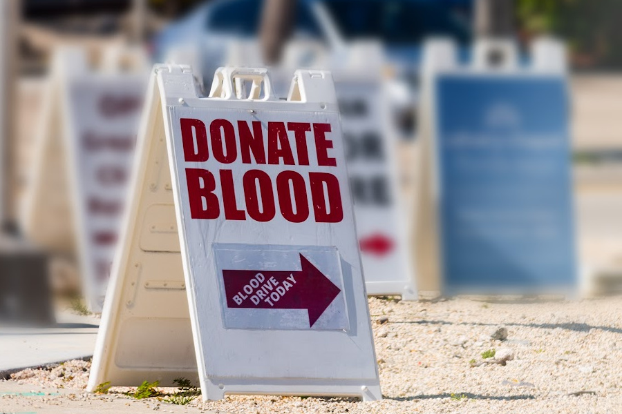 Donate Blood written on a sandwich board sign in USA